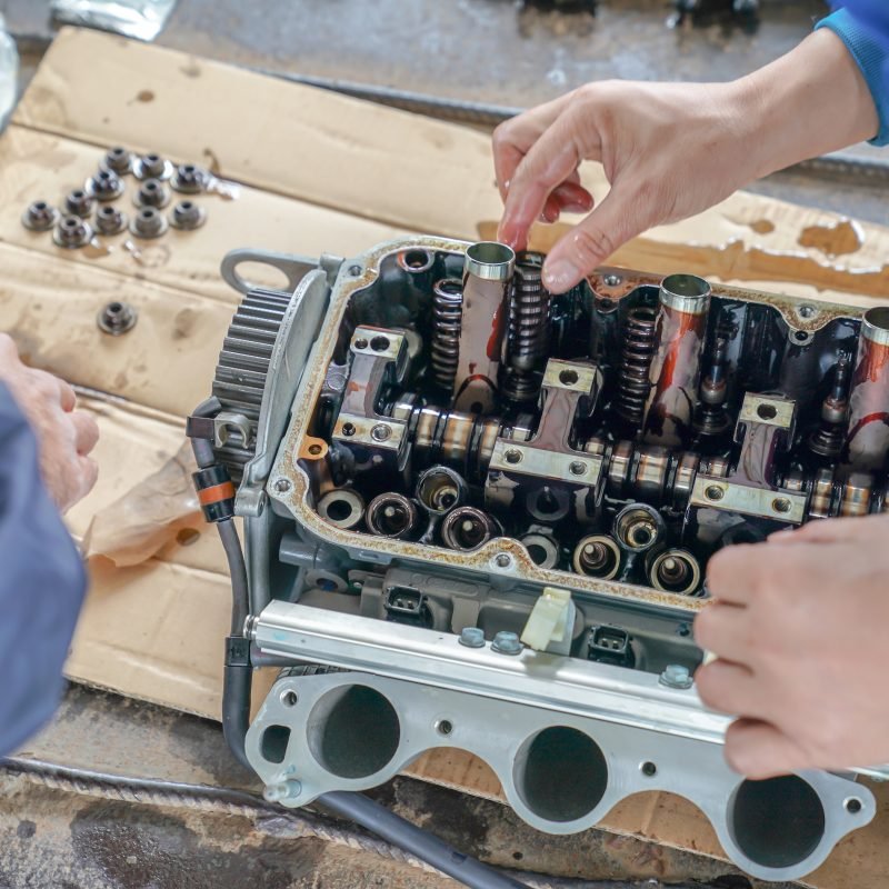 2 mechanic men try to fix and setup boat engine.